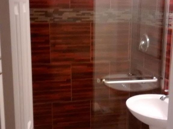 1/2 bath a oversized shower with bench and glass block light