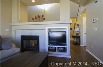Fireplace between cozy family room and formal living room.