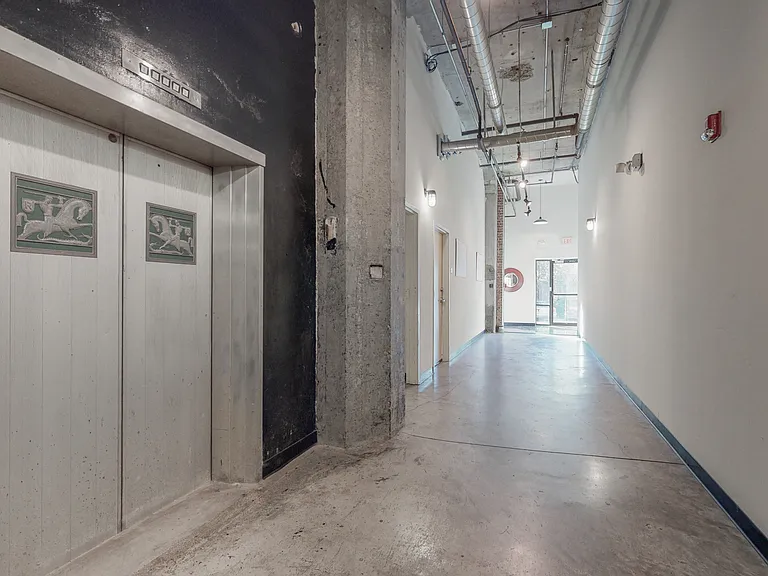 Main Hallway showcasing the original elevator doors with Reynolds Aluminum logo.