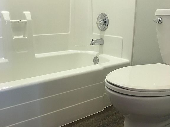 Bright, clean bathroom with shower over tub