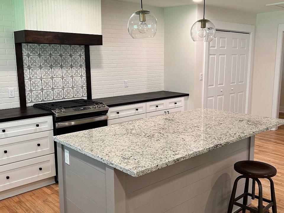 Open floor plan/ Kitchen island/ gas stove/ stainless steel appliances