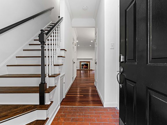 Entryway with stairs to left and downstairs living space.