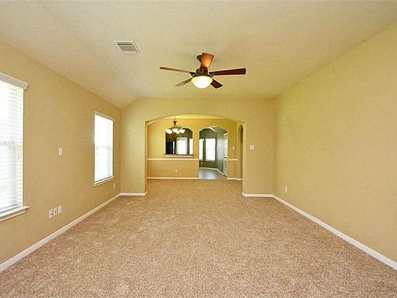THIS SPACIOUS LIVING ROOM WELCOMES YOU AS YOU ENTER THIS BEAUTIFUL HOUSE