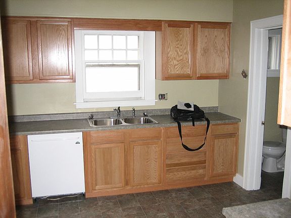 Kitchen with dishwasher, microwave, oven and fridge.