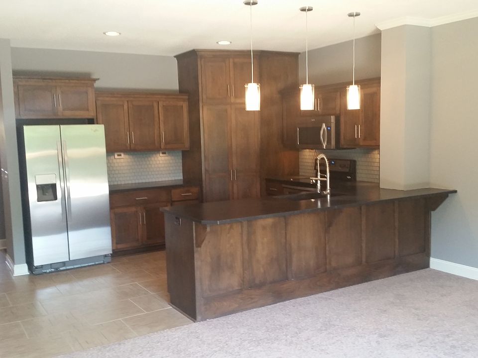 Kitchen with custom cabinets, stainless steel appliances & g