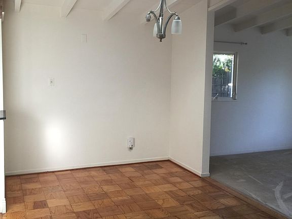 Dining room with light filled sky light. Light Fixture to be changed.