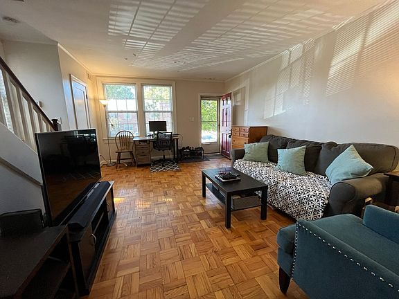 Sunny living room with hardwood floor.