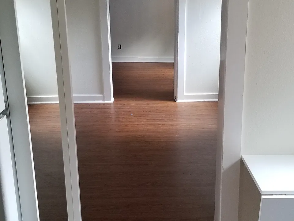 View from Kitchen, through living room, into back bedroom.