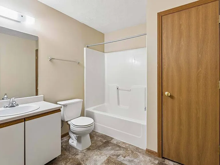A bright, well-appointed bathroom features clean finishes and a full tub and shower combination for everyday comfort and convenience.