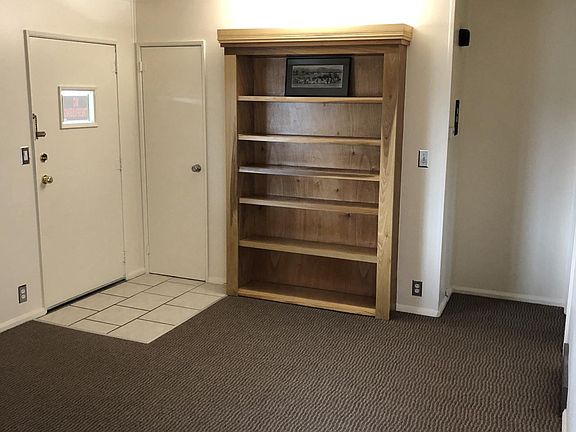 Living room with custom bookcase trimmed in real poplar wood