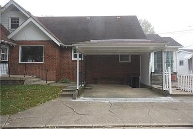 Carport, stairway and door to go into the basement.