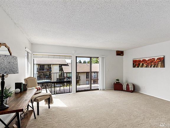 Balcony let's the light shine in! Once on the balcony, you have views of the beautiful grounds, pool & lake!