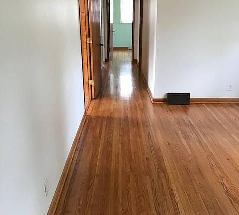 Hallway from living room with refurbished hard wood floors