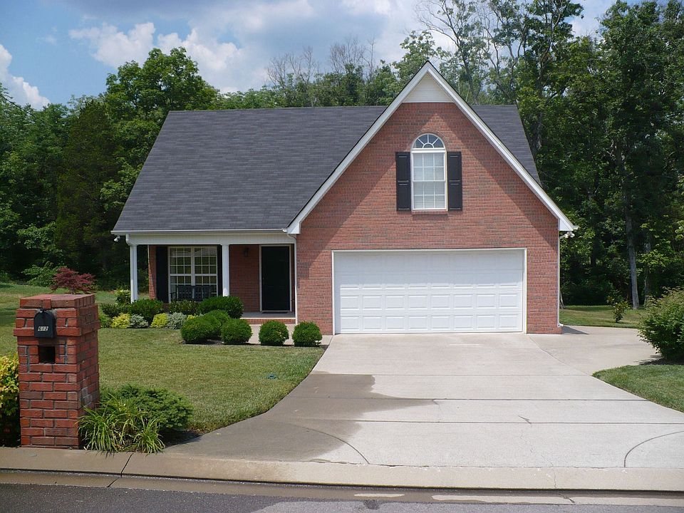 Front view shows custom landscaping