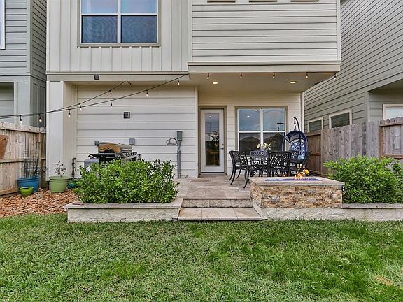 The patio has been extended and has travertine tile flooring, built in gas fireplace with glass rocks, gas connection for gas grill and planters for growing your own vegetables and herbs.