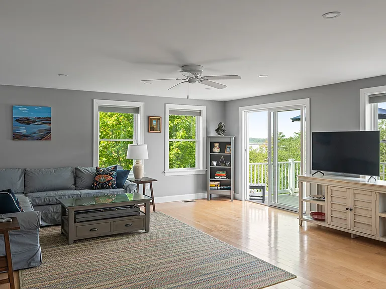 the living room adjacent to the grilling and dining deck