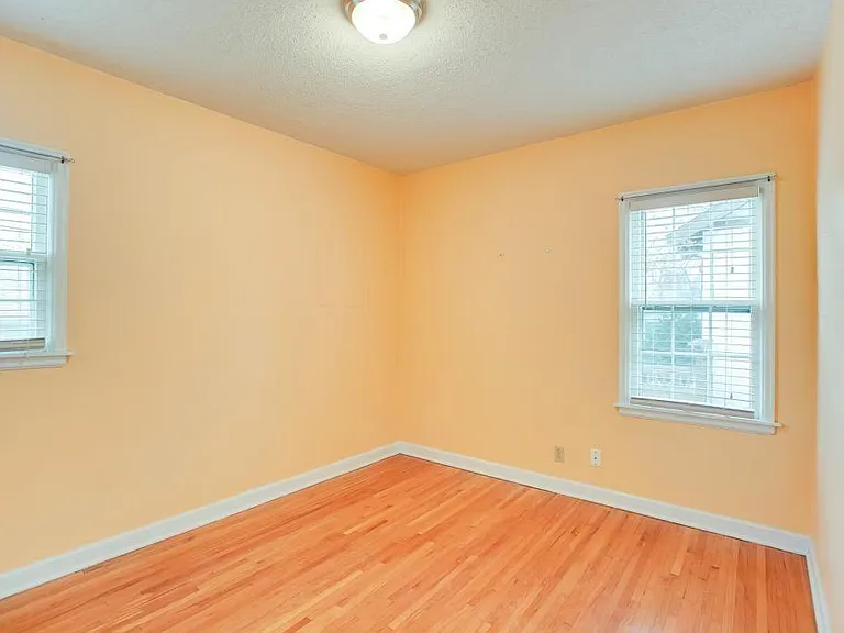 View to SE in second bedroom. Currently room has 3 piece exec desk w/3 raised monitors in corner, wings extending to each window. (Cable internet comes into house through wall outlet. Current upstairs tenant uses as office/game room, and has guest BR.