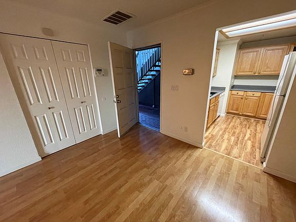 Front door, large closet, and kitchen