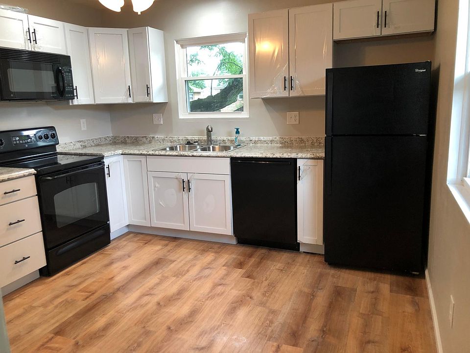 Kitchen with stove, microwave, dishwasher, disposal, and fridge