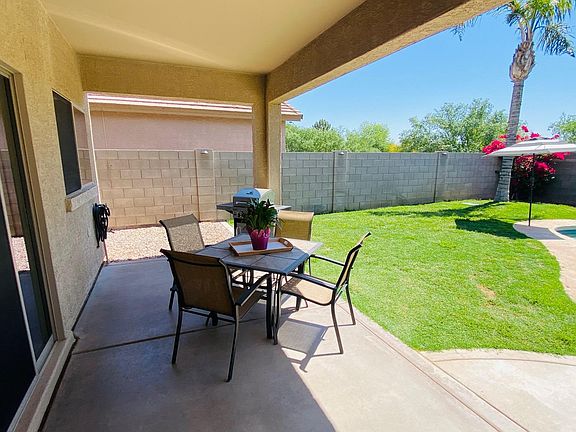 Delightful covered area poolside just outside of the kitchen.