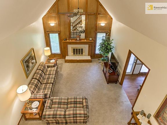 Soaring ceilings in the family room! This room is large enough for 2 sitting areas. Tall windows flanking the fireplace let in a lot of natural light. All wood blinds stay with the home.