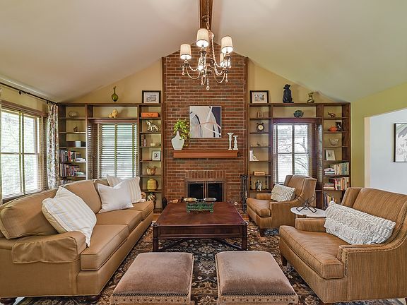 vaulted ceiling, wood burning fire place and built-in bookcases