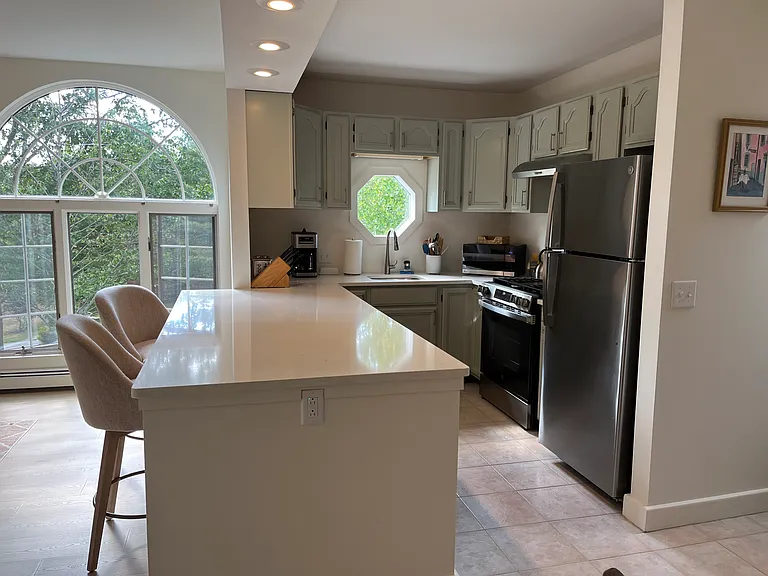 New kitchen quartz countertops and peninsula with new stainless steel appliances and undermount sink for easy cooking and clean up.