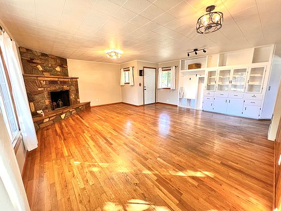 Entry, Living and Dining area with no burn decorative fire place and unique built-ins