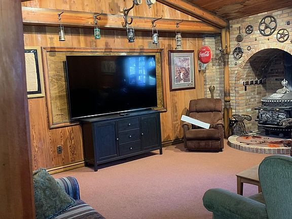 This large room has an oversized ceiling fan and heating. Brand new 90" flat screen TV.