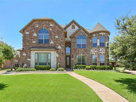 THIS 4465 SQ FT FIRST TEXAS HOME HAS GREAT CURB APPEAL WITH A DECORATIVE BRICK & STONE EXTERIOR!