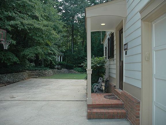 Side entrance & 3 car garage with storage
