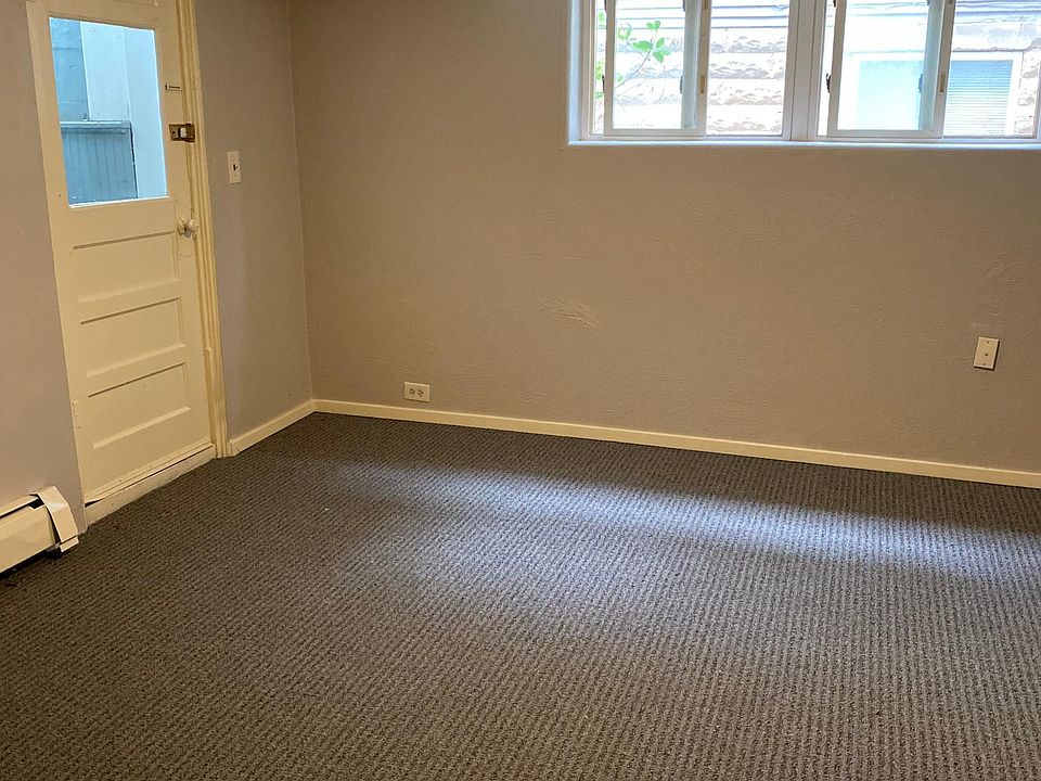 Front living room space is adjacent to counter height pennisula and kitchen