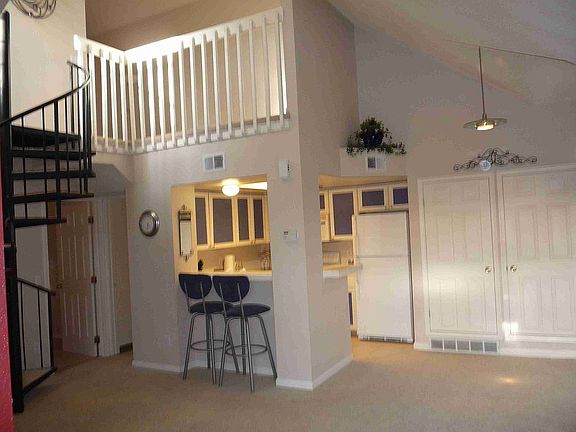 kitchen & loft view from living room-- vaulted ceilings