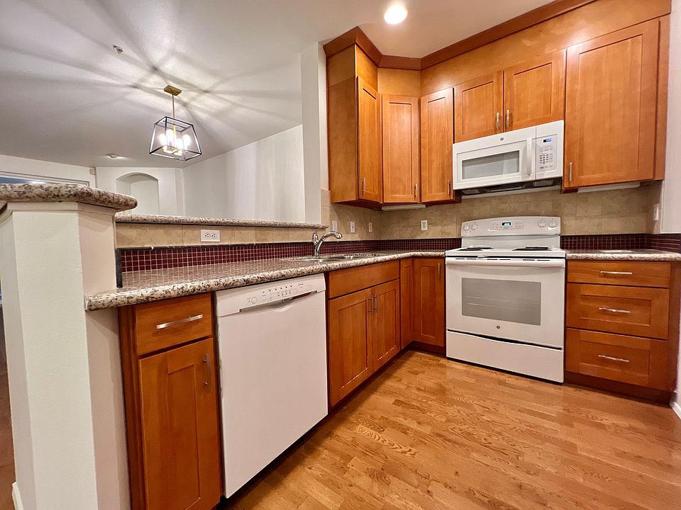 Modern kitchen with gorgeous cabinets, granite countertops, and tiled backsplash