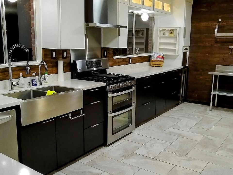 Chef linear kitchen. Gas stove. Rear facing windows with private views day or night. Quartz counter tops. Tile floors. Deep double sink with two faucets. Lighted display cabinet and more.