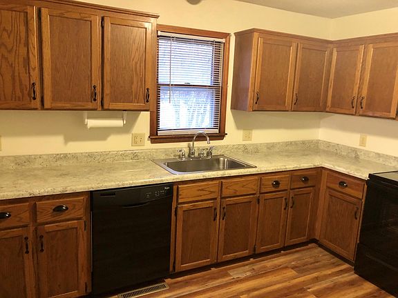 Open kitchen with dishwasher, oven/range, stainless steel farmhouse sink and refrigerator