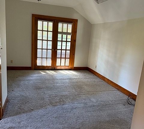 Upstairs bedroom with french doors, skylight.