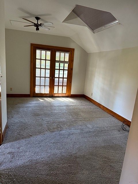 Upstairs bedroom with french doors, skylight.