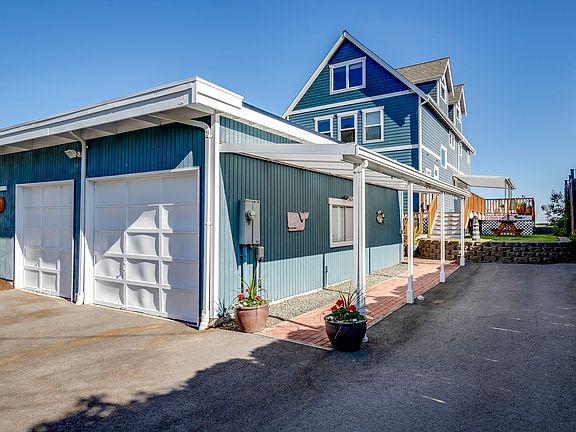 Huge detached two-car garage with small shop space.