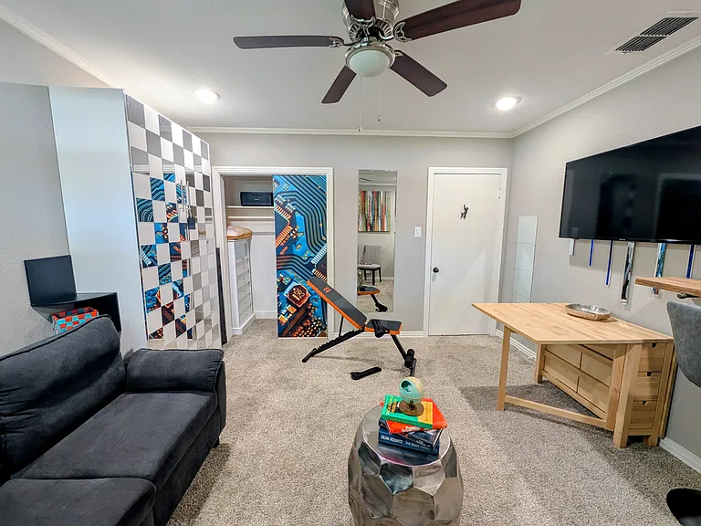 There is a drop-leaf table below the TV.