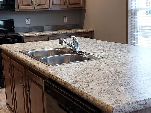 kitchen island with sink and dishwasher