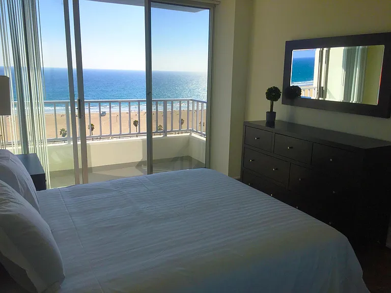Bedroom leads to balcony with ocean views