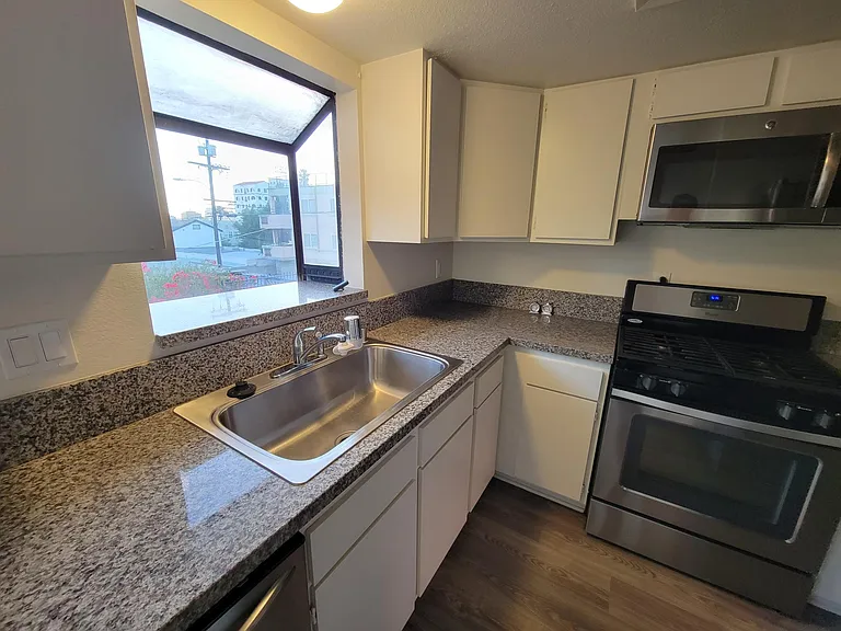 Kitchen: Granite Countertop, Dishwasher, Stainless Steel Sink w Garbage Disposal, Stove, Microwave & Lots of Cabinets