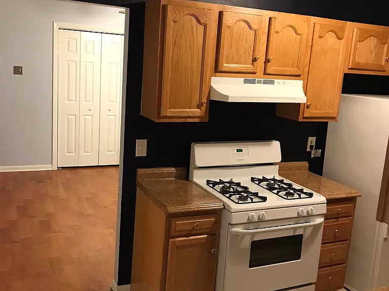 Galley kitchen with gas stove.