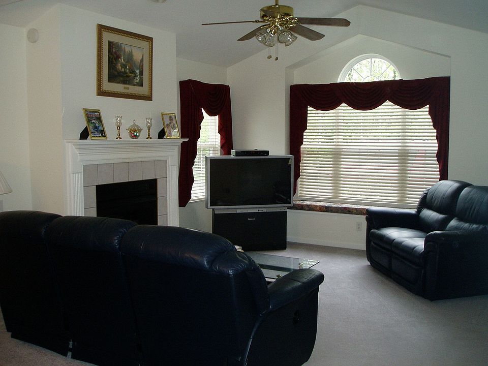 Living Room with cathedral ceiling, fireplace and palladium window