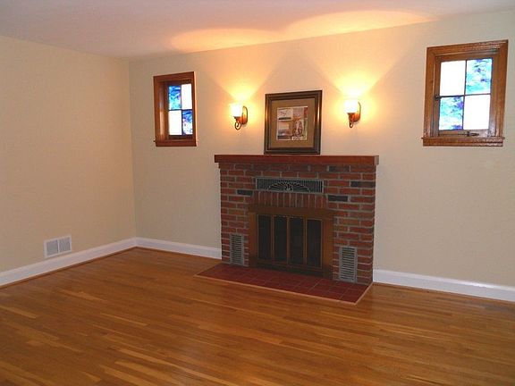 Living Room with fireplace and stained glass windows.