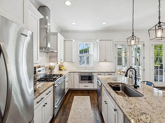 Fully-equipped, modern kitchen with stainless steel appliances, stone countertops, a 5 burner gas stove with double ovens and a walk-in pantry! Seating for 4 at the kitchen island.