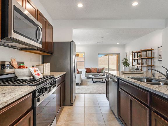 Granite countertops and stainless steel appliances compliment the kitchen