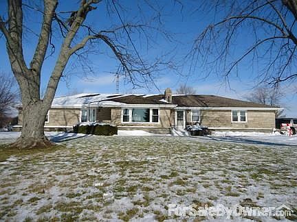 Front view with mature maple trees