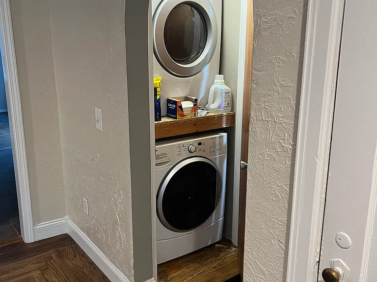 Washer and dryer concealed in hall closet.